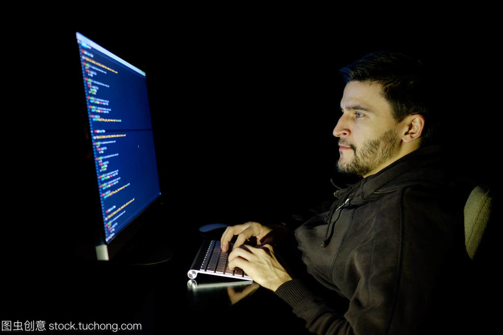 軟件開(kāi)發(fā)人員計(jì)算機(jī)在黑暗的家庭辦公室